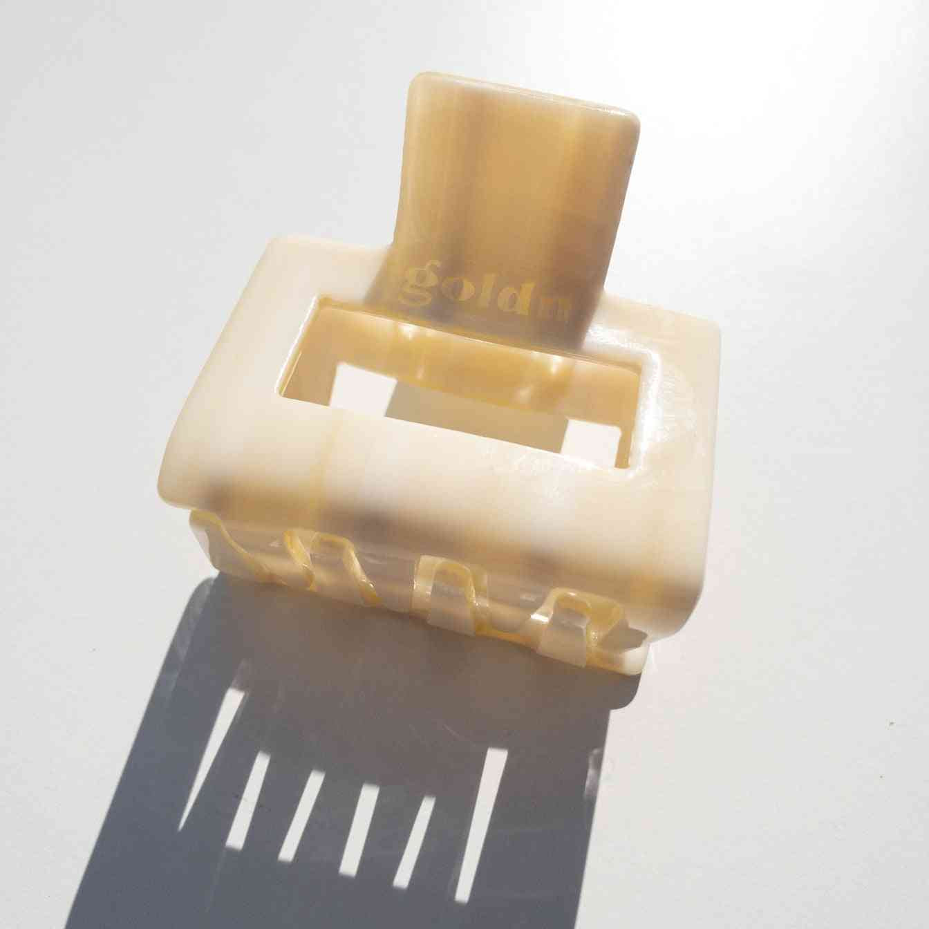 Lounge Claw Clip Small in glossy cream finish with rectangular cutout, designed for secure and stylish hair hold.