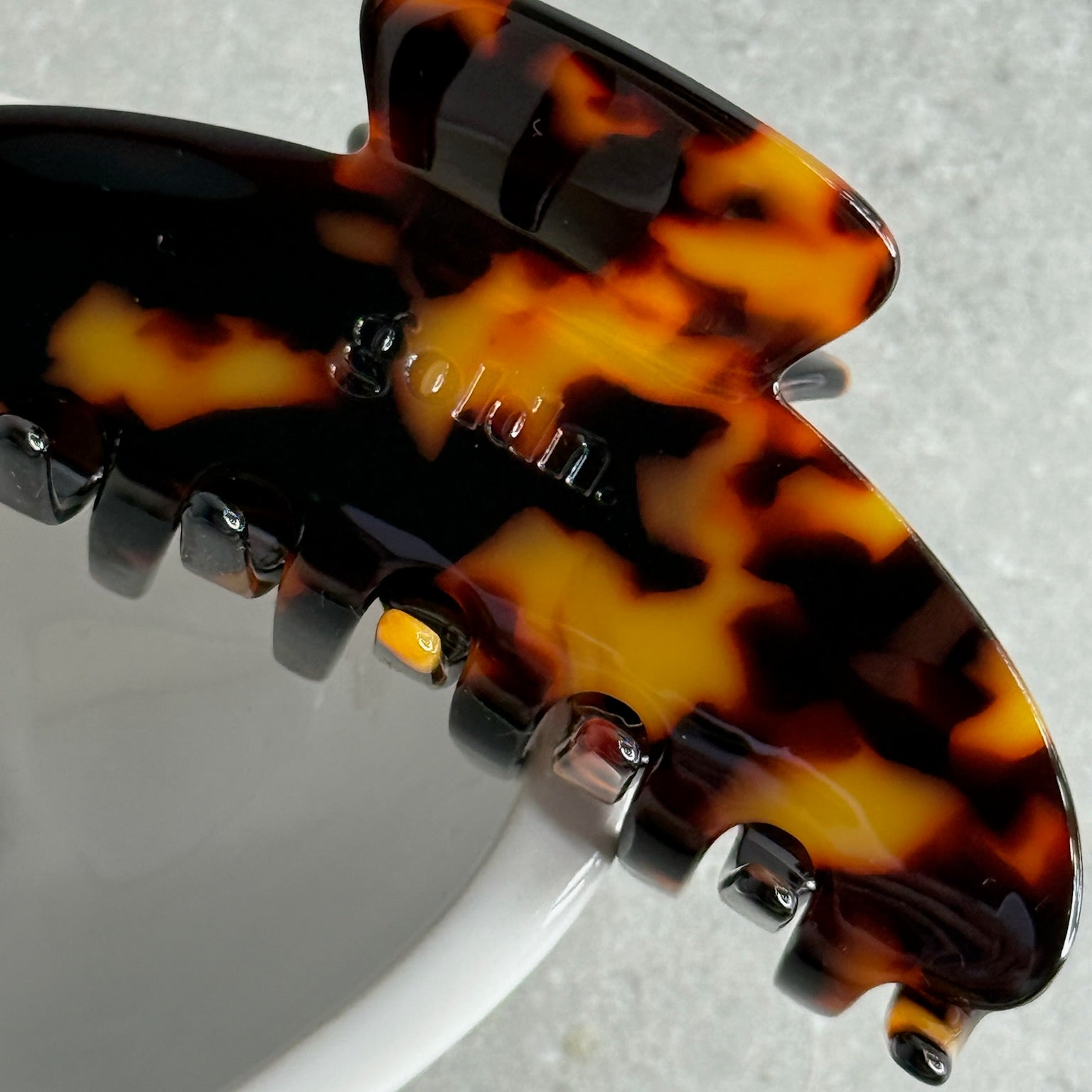 Tortoiseshell hair clip on a light gray background large claw clip for hick hair eco friendly acetate hair accessory 
