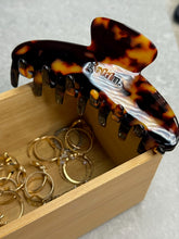 Load image into Gallery viewer, Tortoiseshell hair comb with &#39;Goldn&#39; branding in a wooden box with gold rings.
