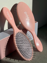 Load image into Gallery viewer, Pink hairbrushes with &#39;Gold&#39;n&#39; logo on a neutral background golden hour
