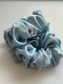 Light blue scrunchie with a small label on a light background