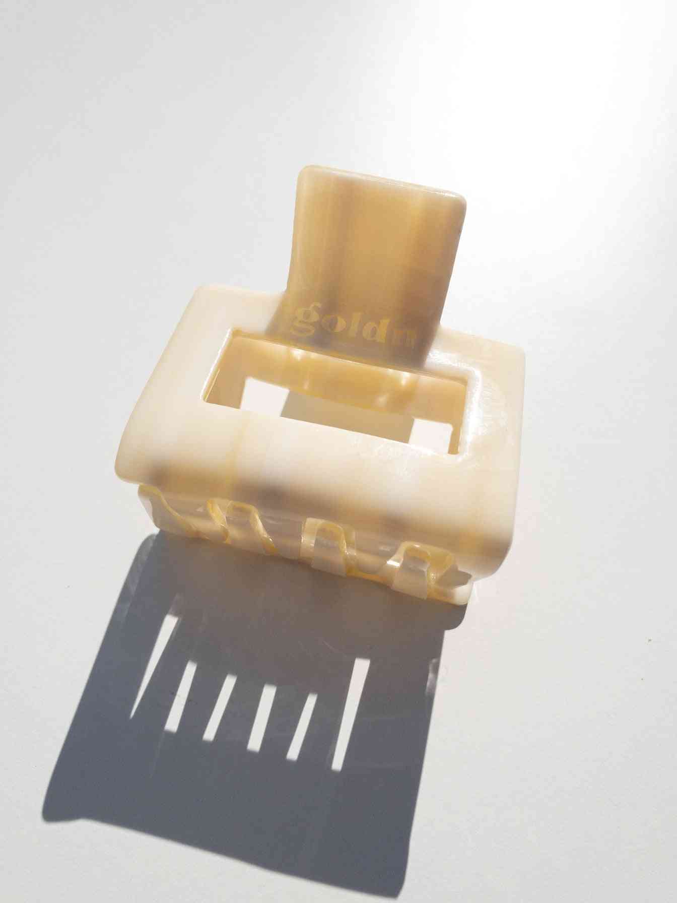 Lounge Claw Clip Small in glossy cream finish with rectangular cutout, designed for secure and stylish hair hold.